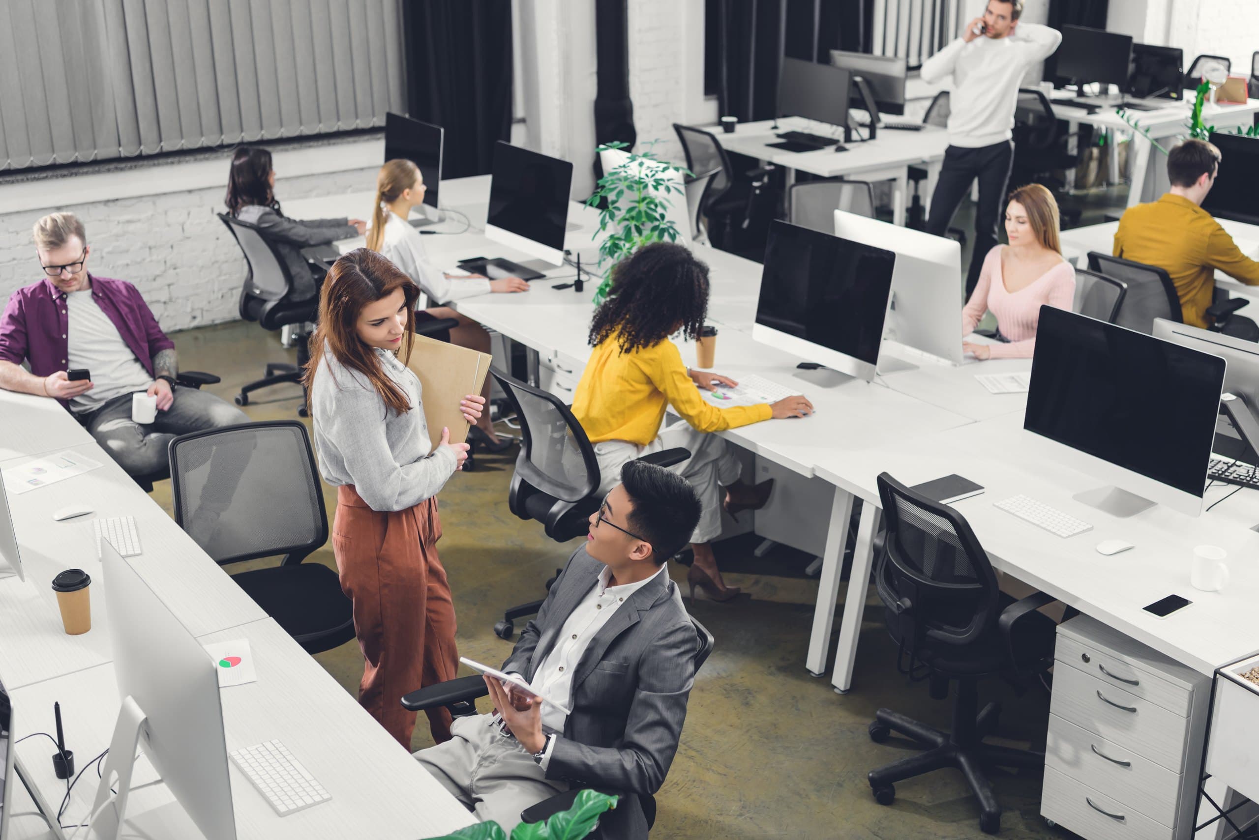 Colleagues working in a bright open-plan office