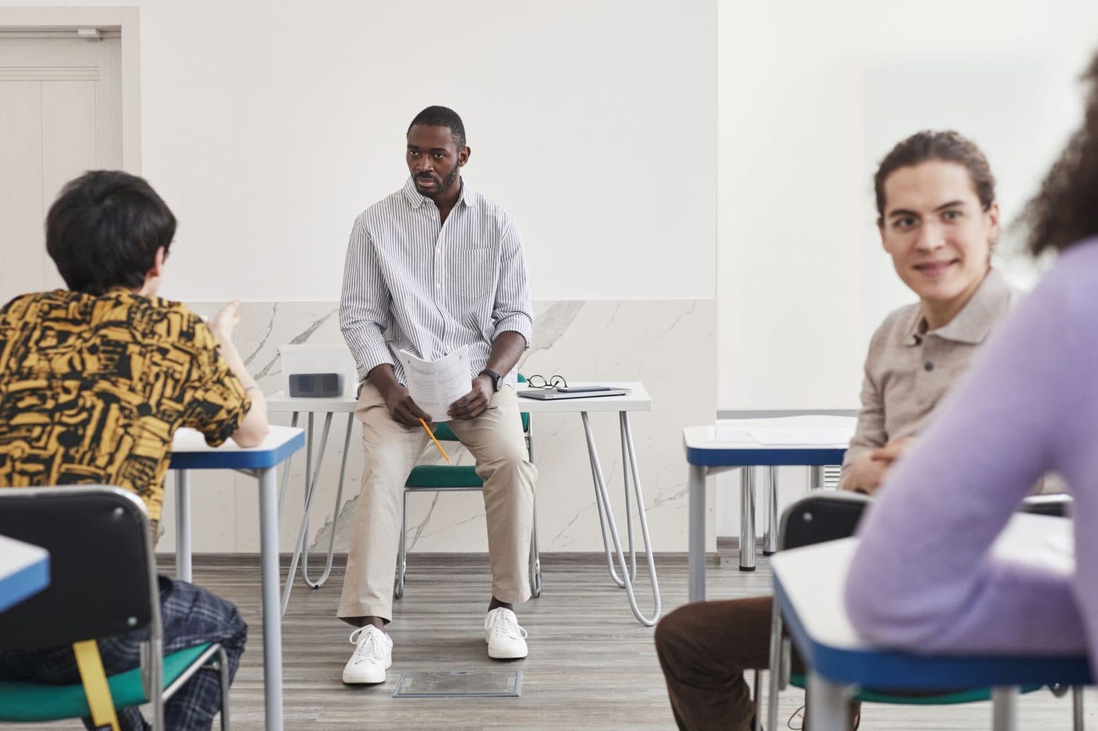 Tutor leading a discussion with a small group of learners